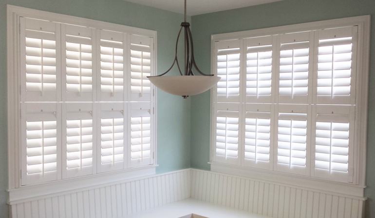 Pastel green wall in Philadelphia kitchen with shutters.